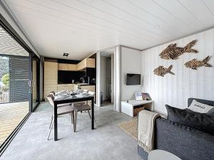 a living room with a table and a couch at Cottage Le Béluga in Jullouville-les-Pins