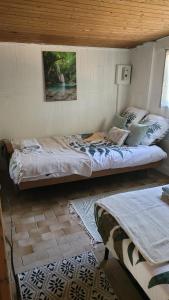a bedroom with a large bed in a room at maisonnette à la campagne in Saint-Mesmin