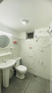 a bathroom with a toilet and a sink at "The Secret Hill" in Matara