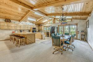 a kitchen and dining room with a table and chairs at Hot Tub and Deck Home 1 Mi to Ruidoso River! in Ruidoso