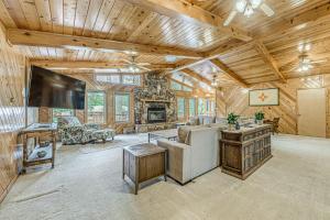 a living room with a couch and a tv at Hot Tub and Deck Home 1 Mi to Ruidoso River! in Ruidoso