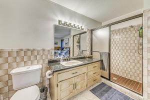 a bathroom with a toilet and a sink and a shower at Hot Tub and Deck Home 1 Mi to Ruidoso River! in Ruidoso +25 photos