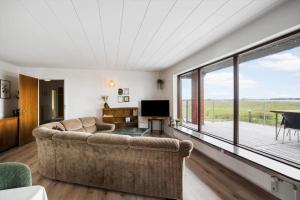 a living room with a couch and a large window at JB244-Logstor-Aggersborgvej-51 in Løgstør