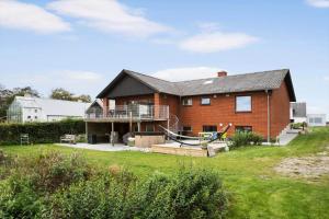 a large red brick house with a porch and a balcony at JB244-Logstor-Aggersborgvej-51 in Løgstør