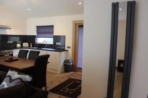 A television and/or entertainment center at Loch Ness Highland Cottages with partial Loch View