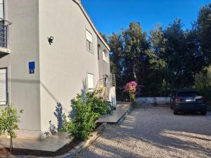 a car is parked next to a building at AP JURISIC in Bibinje
