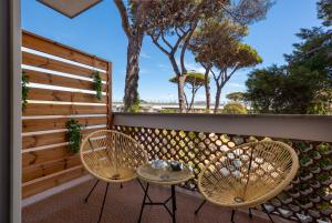 two chairs and a table on a balcony at L'Altalena in Fiumicino