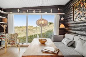 a living room with a table and a large window at JB119-Brovst-Ejstrup-Strandvej-18 in Brovst
