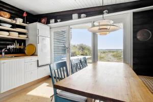 a kitchen with a wooden table and a dining room at JB119-Brovst-Ejstrup-Strandvej-18 in Brovst
