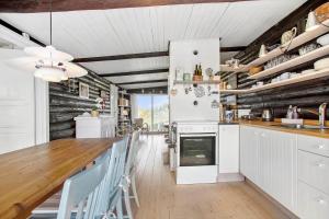 a kitchen with white appliances and wooden walls at JB119-Brovst-Ejstrup-Strandvej-18 in Brovst