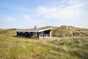 a small house sitting on top of a hill at JB119-Brovst-Ejstrup-Strandvej-18 in Brovst +15 photos