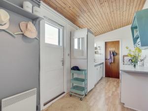 a room with a door and a kitchen with a shelf at Holiday Home Felis - 200m from the sea by Interhome in Saltum