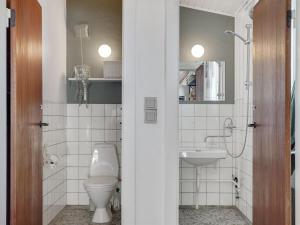 a bathroom with a toilet and a sink at Holiday Home Felis - 200m from the sea by Interhome in Saltum