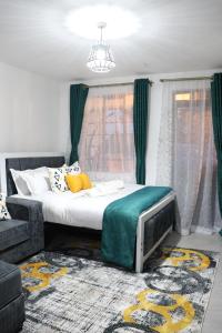 a bedroom with a bed and a couch at Gray Havens Homes in Rungiri