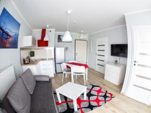 a living room with a couch and a table at Apartament Międzyzdroje Horyzont Blue in Międzyzdroje