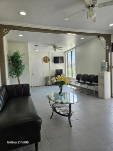 a living room with a couch and a glass table at Rodeway Inn Hattiesburg North in Hattiesburg