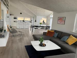 a living room with a couch and a table at Holiday Home Antina - 400m from the sea by Interhome in Hjørring