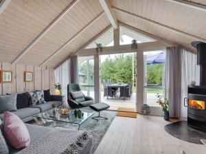 a living room with a couch and a fireplace at Holiday Home Varpu - 1-6km from the sea by Interhome in Saltum