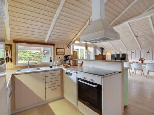 a kitchen with a sink and a stove top oven at Holiday Home Varpu - 1-6km from the sea by Interhome in Saltum +12 photos