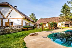 a house with a swimming pool in front of a yard at Nature rezidence private wellness in Zahorčice