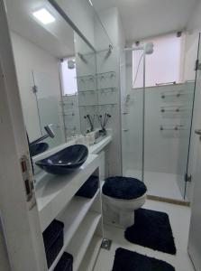 a bathroom with a sink and a toilet and a shower at Apartamento in Ananindeua
