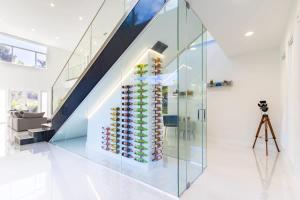 a wall of wine bottles in a glass case at Brand new Luxurious Villa in Hollywood Beach