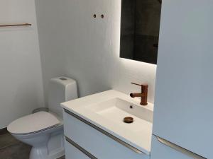 a bathroom with a white sink and a toilet at Apartment Almar - 293m from the sea by Interhome in Hjørring
