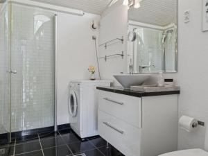 a bathroom with a washing machine and a sink at Holiday Home Ilsabet - 750m from the sea by Interhome in Gilleleje +15 photos