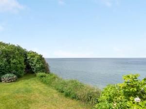 a field of grass next to the ocean at Holiday Home Orwik - 30m from the sea by Interhome in Hundested