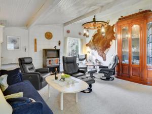 a living room with a couch and chairs and a table at Holiday Home Simon - 225m from the sea by Interhome in Klint