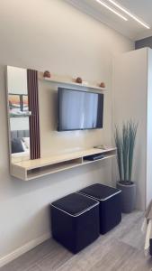 a living room with two stools in front of a tv at Maravilloso Apartamento Copacabana in Rio de Janeiro +28 photos