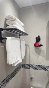 a bathroom with white towels on a shelf at Maravilloso Apartamento Copacabana in Rio de Janeiro
