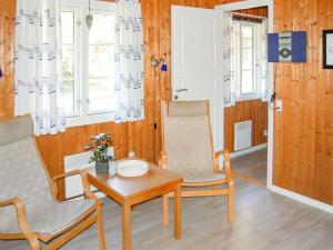 a living room with two chairs and a table at Holiday Home Ulla - 300m from the sea by Interhome in Neksø