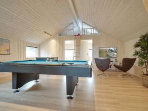 a large room with a pool table in it at Holiday Home Vara - 800m from the sea by Interhome in Vejby +21 photos