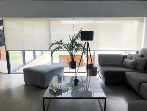 a living room with a couch and a coffee table at Casa Tilin in Valtierra