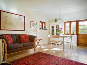 a living room with a couch and a table at Holiday Home Ingwald - 50m from the sea by Interhome in Skagen