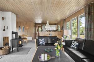 a living room with a couch and a table at JB102-Fjerritslev-Blabaerstien-7 in Fjerritslev