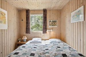 a bedroom with a large bed and a window at JB102-Fjerritslev-Blabaerstien-7 in Fjerritslev
