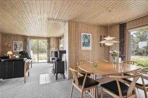 a dining room with a table and chairs at JB102-Fjerritslev-Blabaerstien-7 in Fjerritslev +17 photos