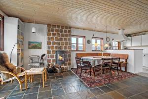 a kitchen and dining room with a table and chairs at JB144-Frostrup-Horsbakkevej-7 in Lild Strand