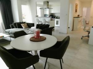 a living room with a white table and chairs at Hillfort suites in Lostorf