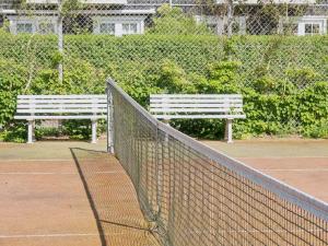 a white bench sitting on a tennis court at Apartment Galia - 2km from the sea by Interhome in Rørvig +25 photos