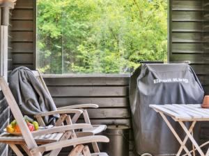 a trash can and a table and chairs on a porch at Holiday Home Nititzki - 600m from the sea by Interhome in Nykøbing Sjælland