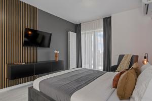 a bedroom with a bed and a tv on a wall at Terracotta Oasis in Bucharest
