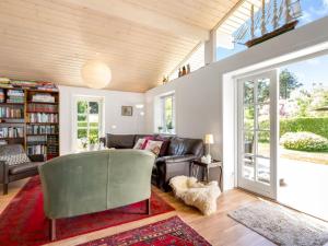 een woonkamer met een bank en een tafel bij Holiday Home Melle - 350m from the sea by Interhome in Dronningmølle