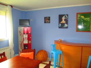 a kitchen with a blue wall with a red refrigerator at Hotel Brisas del Sella in Ribadesella