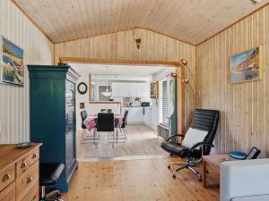 a kitchen and living room with a table and chairs at Holiday Home Ludvika - 350m from the sea by Interhome in Tjørneholm