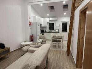a living room with a couch and a table at Ana's Nest in Horta