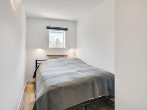 a bed in a white room with a window at Holiday Home Sighmund - 530m from the sea by Interhome in Yderby