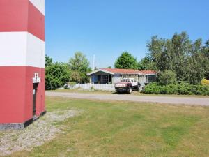 a house with a truck parked in front of a building at Holiday Home Enrik - 123m from the sea by Interhome in Vordingborg